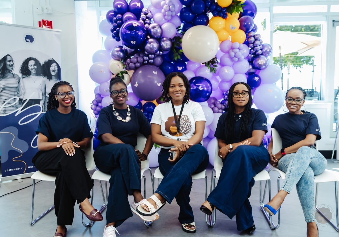 Five Black women are seated on chairs.