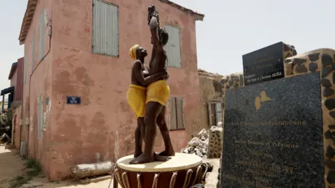 Reuters A statue commemorating the abolition of slavery stands in front of the House of Slaves museum, before being relocated to the "Freedom and Human Dignity" Square, on Goree island, off the coast of Dakar, Senegal July 3, 2020