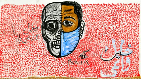 Getty Images Urban art depicting the importance of face masks, part of a Covid-19 campaign, is pictured with the Arabic hashtag ‘Stay aware’ in Khartoum (Credit: Getty Images)