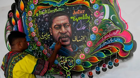 Asif Hassan / AFP/ Getty Images Truck artist Haider Ali puts the final touches to his Floyd tribute in Karachi (Credit: Asif Hassan / AFP/ Getty Images)