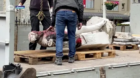 Reuters This TV image shows a statue of Leopold defaced and damaged by fire being removed in Antwerp