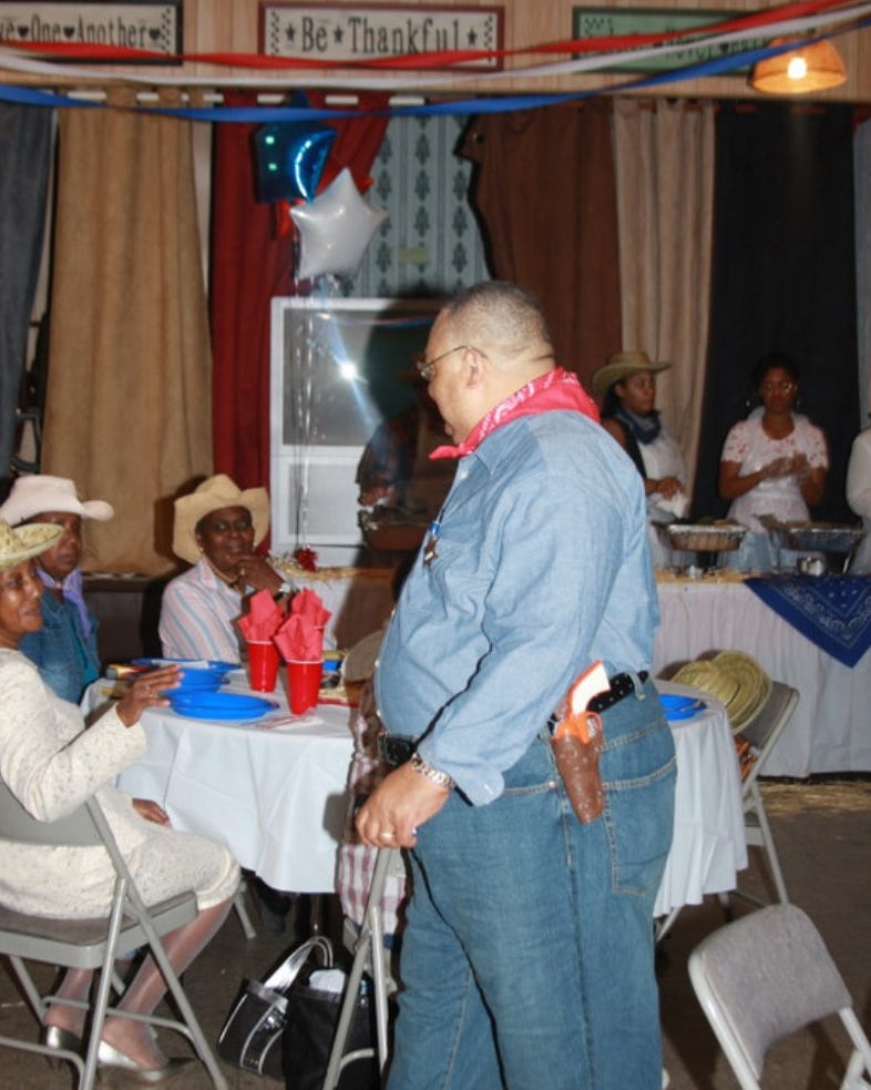 a person standing in front of a table with a group of people sitting at tables